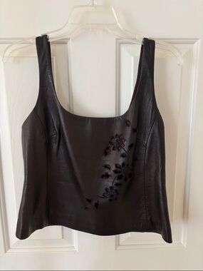 Emanuel: Soft leather vest lined in Burgandy with floral appliqué signature fo